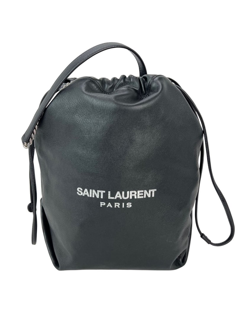 Saint Laurent Lambskin Teddy Black Drawstring Bucket Bag with Fringe Accent: Saint Laurent Lambskin Teddy Black Drawstring Bucket Bag with Fringe Accent Elevate your accessory collection with the Saint Laurent Lambskin Teddy Drawstring Sac Bucket Bag. This medium-sized bag fea