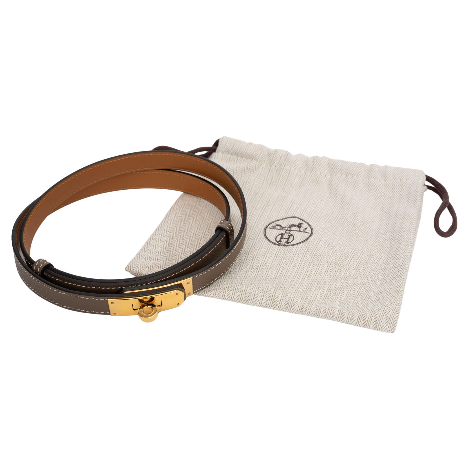 Hermes Etoupe Epsom Leather Gold Kelly Belt with Dust Cover: Hermes Etoupe Epsom Leather Gold Kelly Belt with Dust Cover This exquisite Hermes Kelly Belt is crafted from luxurious Etoupe Epsom leather and features a stunning gold Kelly turn lock closure on the