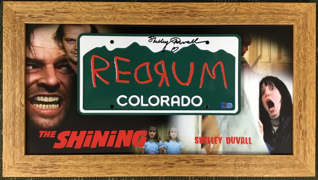 Shelley Duvall Signed The Shining License Plate Display AIV Authenticated: Shelley Duvall Signed The Shining License Plate Display AIV Authenticated This exceptional piece features a custom framed display of a Colorado license plate inscribed with "RedRum," signed by actress