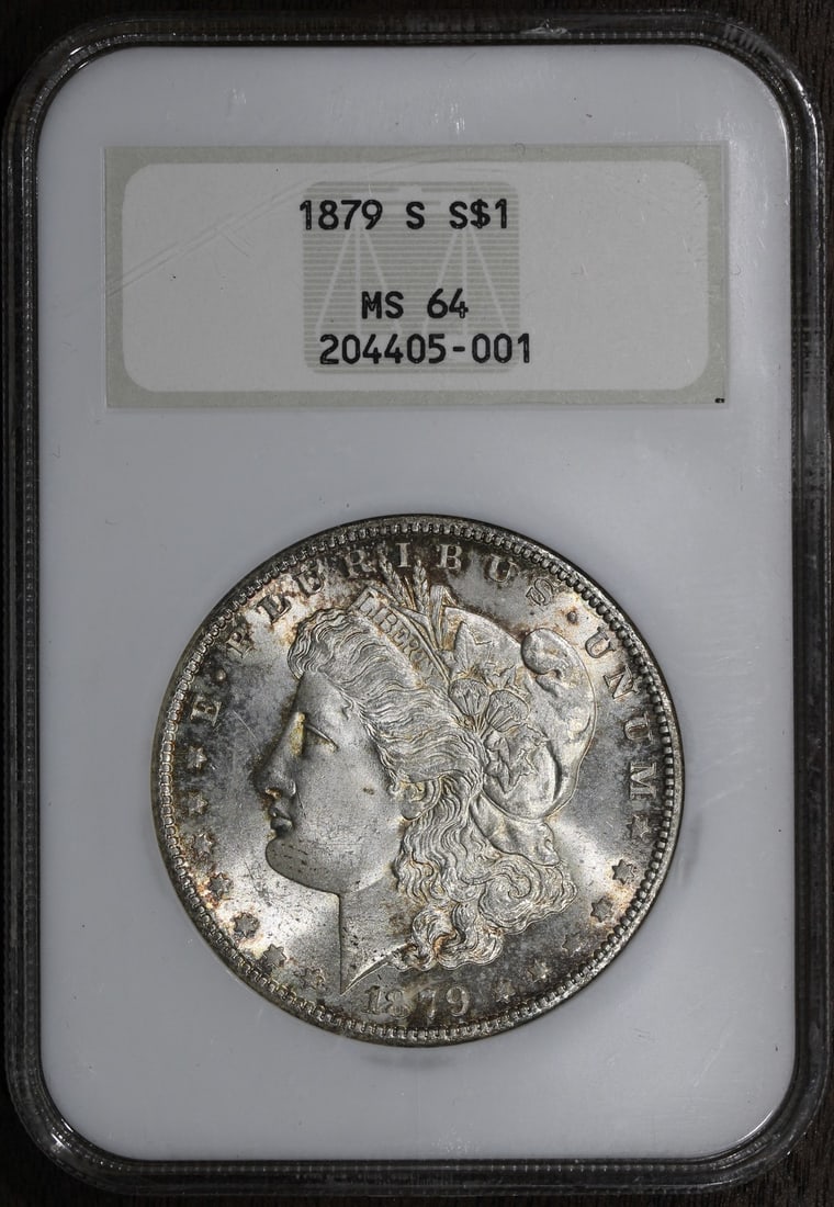 1879-S NGC MS64 Morgan Silver Dollar in Old Holder: 1879-S NGC MS64 Morgan Silver Dollar in Old Holder This 1879-S Morgan Silver Dollar is graded MS64, indicating it is in uncirculated condition, showcasing minimal wear. Struck in silver with a finenes
