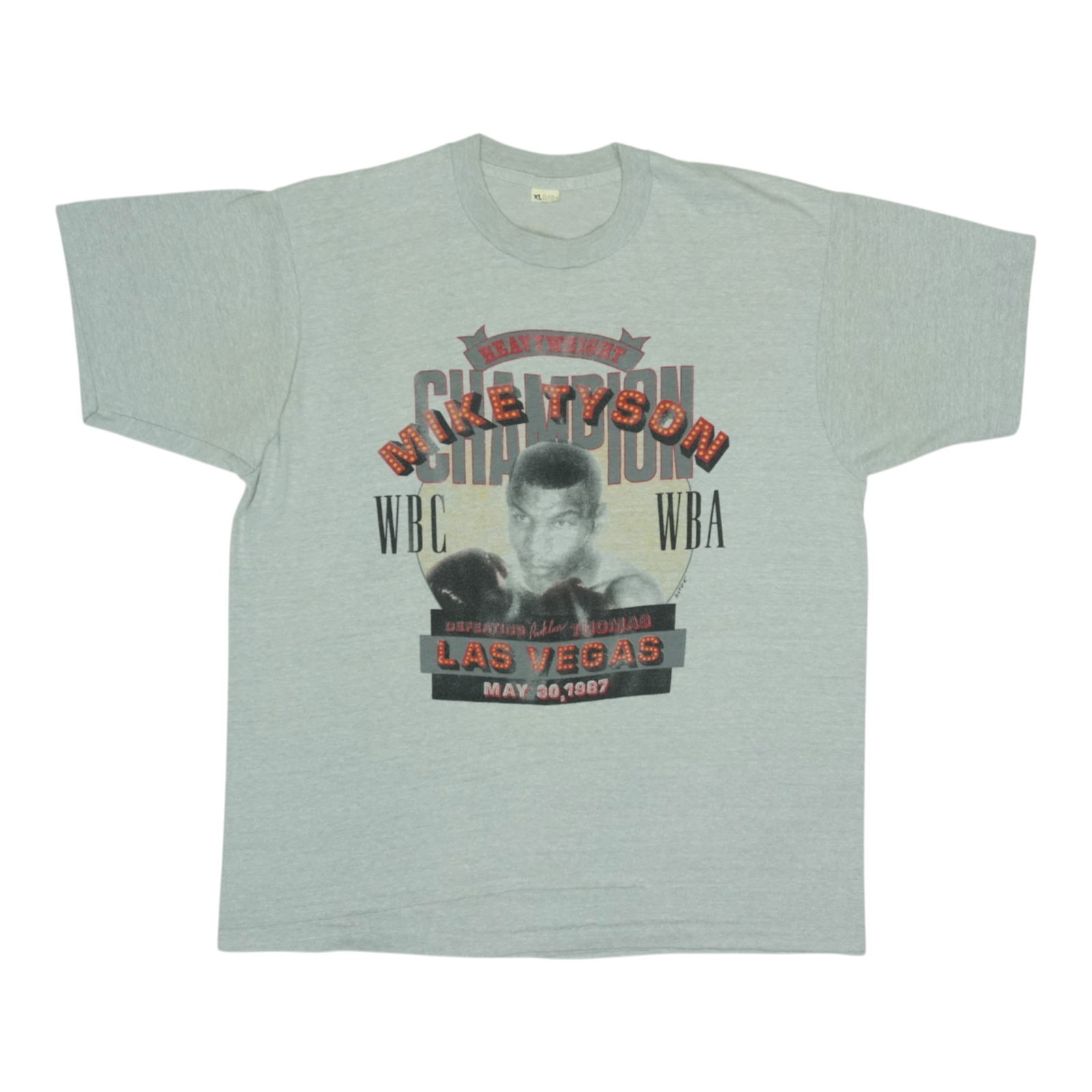 1987 Vintage Mike Tyson Heavyweight Champion Grey Shirt: 1987 Vintage Mike Tyson Heavyweight Champion Grey Shirt Presenting an original vintage 1987 Mike Tyson Heavyweight Champion Shirt, a true collectible and piece of boxing history. This shirt, crafted f