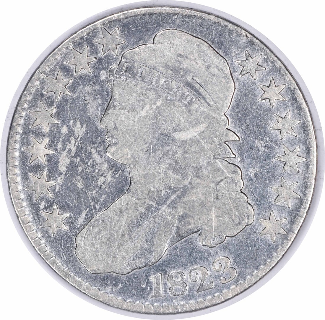 1823 Bust Half Dollar 50C John Reich Vintage Grade Uncertified: 1823 Bust Half Dollar 50C John Reich Vintage Grade Uncertified This 1823 Bust Half Dollar is a classic piece of American numismatics, featuring a design by John Reich. The coin is circulated, showcasi