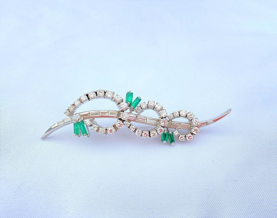 1960s French Platinum Diamond Emerald Brooch 2.50 ct Diamonds 0.85 ct Emerald: 1960s French Platinum Diamond Emerald Brooch 2.50 ct Diamonds 0.85 ct Emerald This exquisite French brooch, crafted in the 1960s, features a stunning combination of diamonds and emeralds set in luxuri
