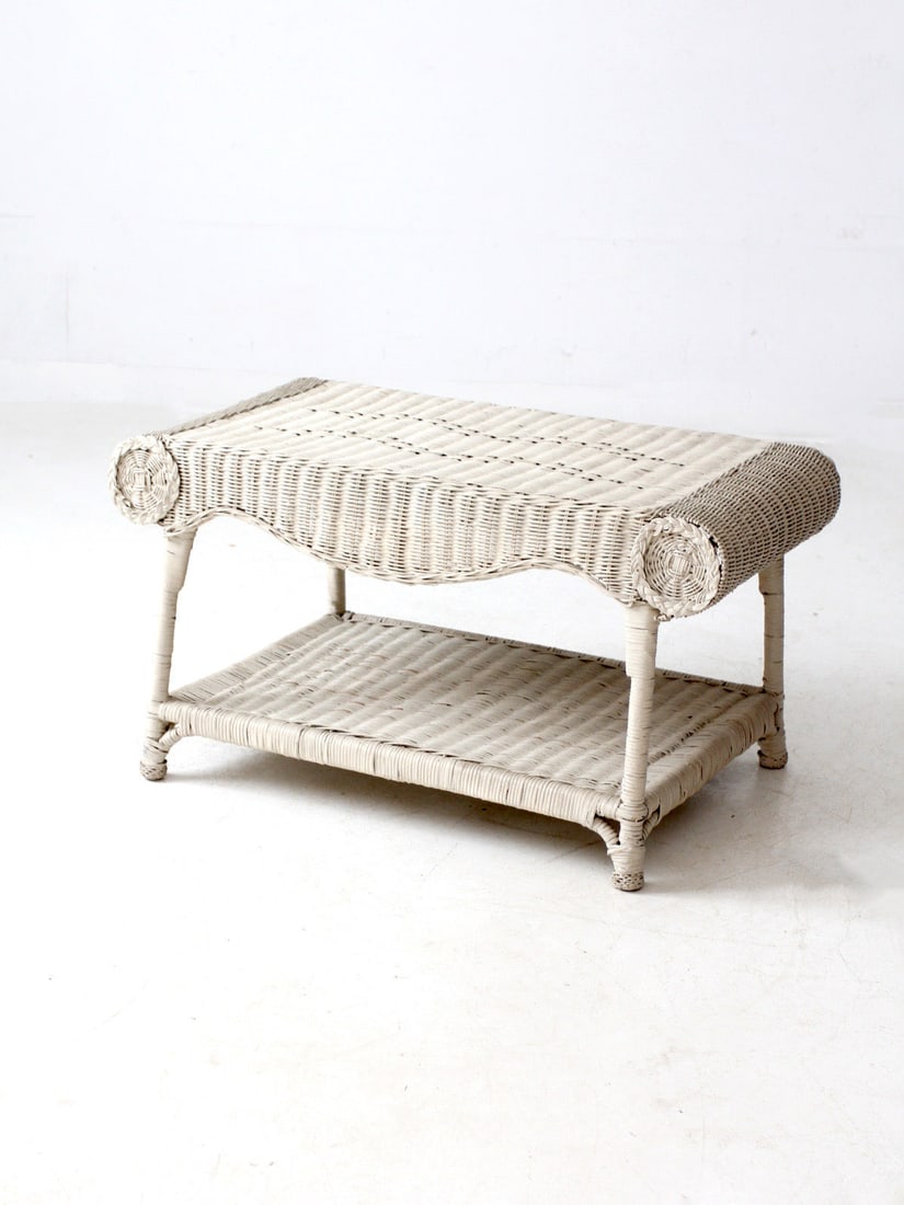 Charming Antique White Wicker Coffee Table with Scrolled Ends: Charming Antique White Wicker Coffee Table with Scrolled Ends This charming antique white wicker coffee table is a versatile addition to any living space, serving as a coffee table, bench, or end tabl