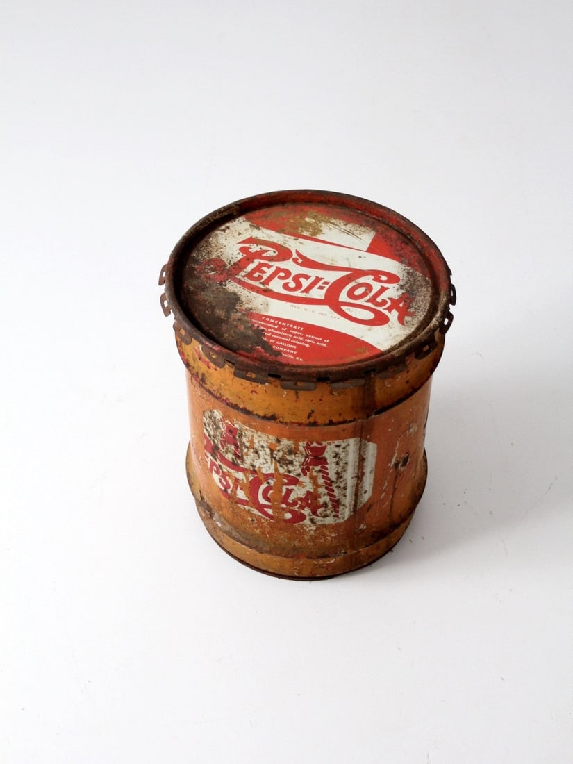1940s Vintage Pepsi-Cola 10 Gallon Industrial Syrup Drum: 1940s Vintage Pepsi-Cola 10 Gallon Industrial Syrup Drum Discover a piece of history with this vintage Pepsi-Cola syrup industrial drum dating back to the 1940s. Crafted from heavy metal, this 10-gall