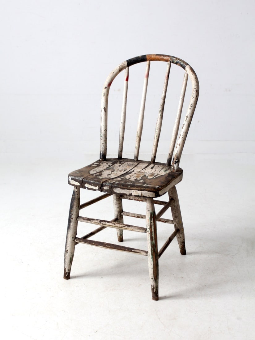 Antique Windsor Spindle Back Chair Distressed White Finish: Antique Windsor Spindle Back Chair Distressed White Finish This antique spindle back chair features a charming distressed white finish that adds a touch of rustic elegance to any setting. Designed in