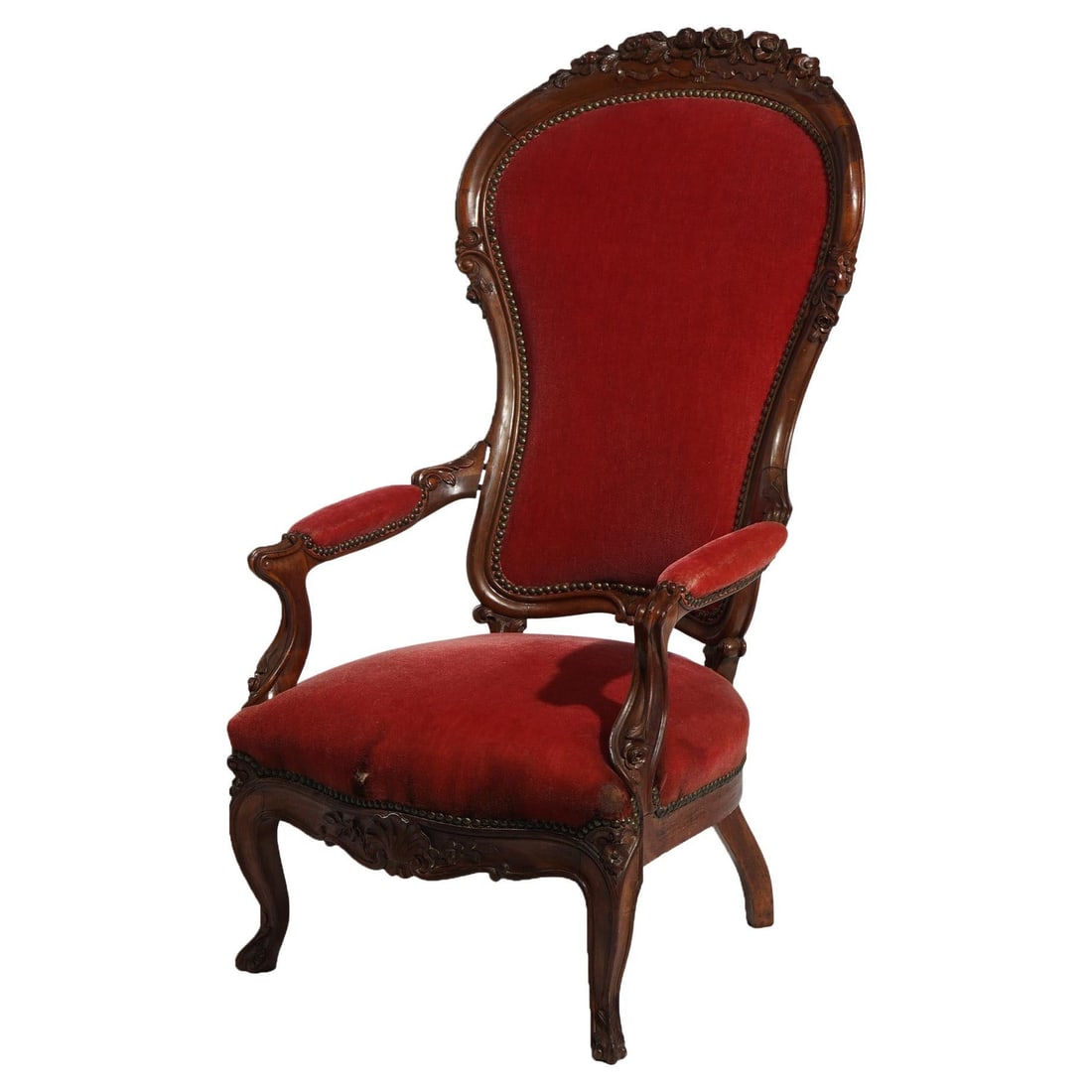 Antique Victorian Carved Walnut Armchair C1890 Upholstered Red Fabric: Antique Victorian Carved Walnut Armchair C1890 Upholstered Red Fabric This exquisite Antique Victorian Oversized Carved Walnut Armchair, dating back to circa 1890, showcases the exceptional craftsmans