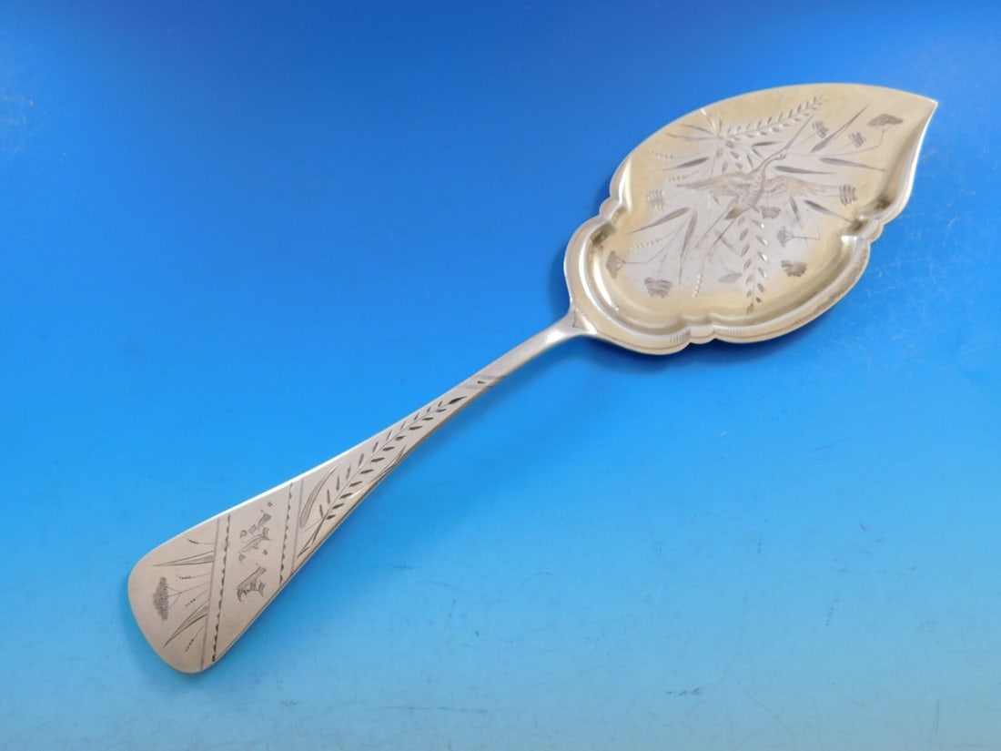 Vintage Brite-Cut Sterling Silver Ice Cream Server with Bird Motif: Vintage Brite-Cut Sterling Silver Ice Cream Server with Bird Motif This elegant ice cream server features a sterling silver composition with a distinctive brite-cut design. The flat handle is adorned