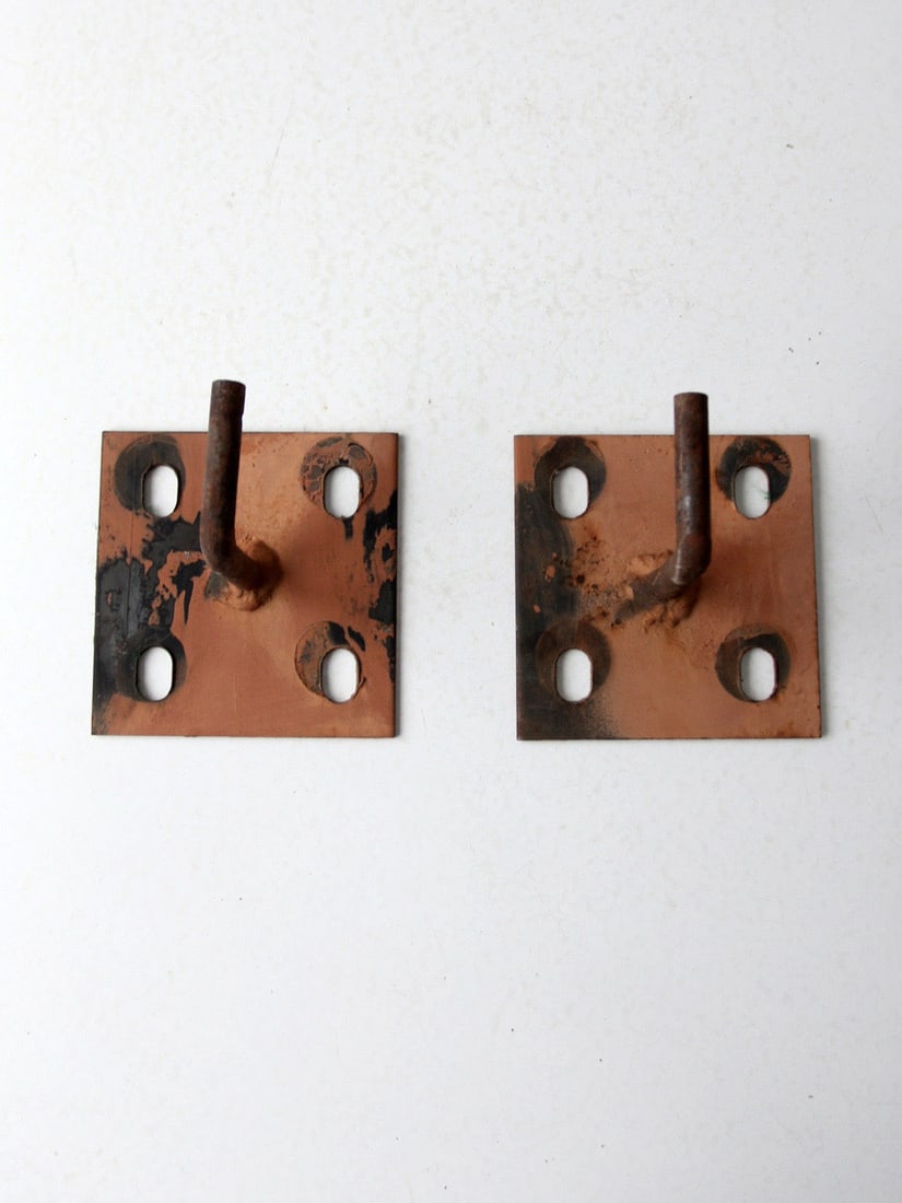 Vintage Industrial Metal Hooks Aged Peach Tone Pair: Vintage Industrial Metal Hooks Aged Peach Tone Pair Enhance your space with this pair of vintage industrial hardware hooks. Crafted from metal, these hooks feature a plate-style backing with screw hol
