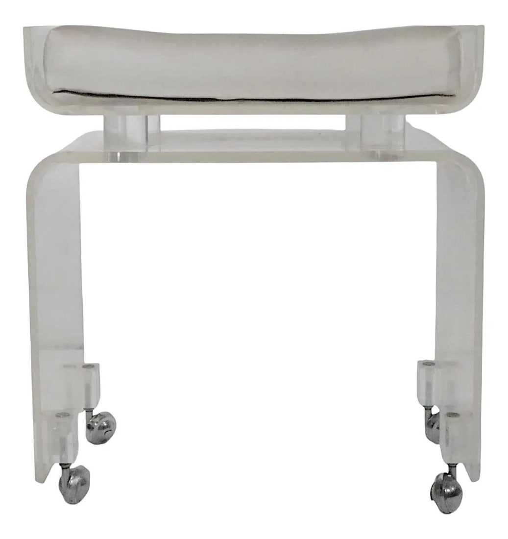 Hollywood Regency Lucite Vanity Bench by Hill Manufacturing Co: Hollywood Regency Lucite Vanity Bench by Hill Manufacturing Co This chic Hollywood Regency style vanity bench features a thick lucite frame and a comfortable vinyl padded seat. The stool showcases an