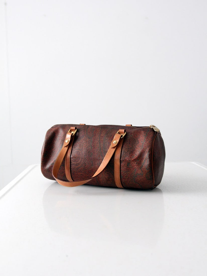 Vintage Etro Paisley Print Handbag with Leather Handles: Vintage Etro Paisley Print Handbag with Leather Handles Discover a charming vintage Etro handbag, perfect for adding a touch of elegance to any outfit. This small duffle tote showcases a classic paisl