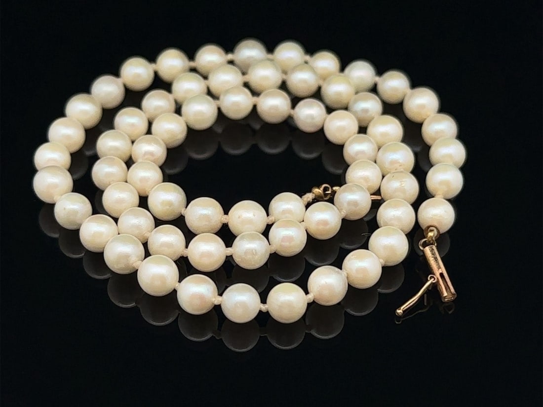 17 Inch Cultured Pearl Necklace with 14k Yellow Gold Clasp: 17 Inch Cultured Pearl Necklace with 14k Yellow Gold Clasp This elegant 17-inch strand necklace features 64 genuine cultured pearls in a baroque shape, showcasing a beautiful white color with a lovely