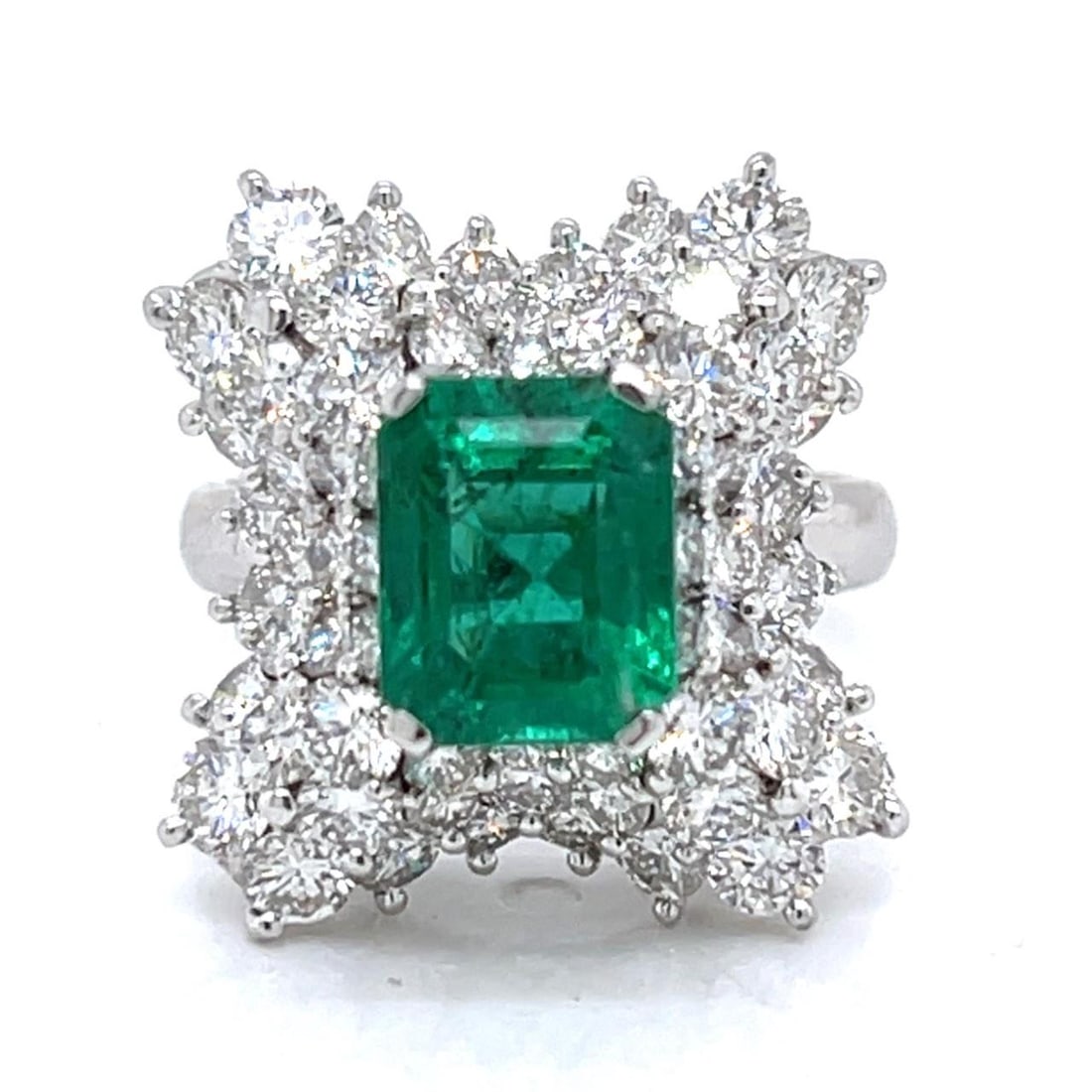 1960's Platinum Emerald 2.36 Ct Diamond Cocktail Ring: 1960's Platinum Emerald 2.36 Ct Diamond Cocktail Ring This exquisite 1960's Platinum Cocktail Ring showcases a stunning 2.36 Ct. emerald, elegantly complemented by 66 diamonds totaling approximately 4