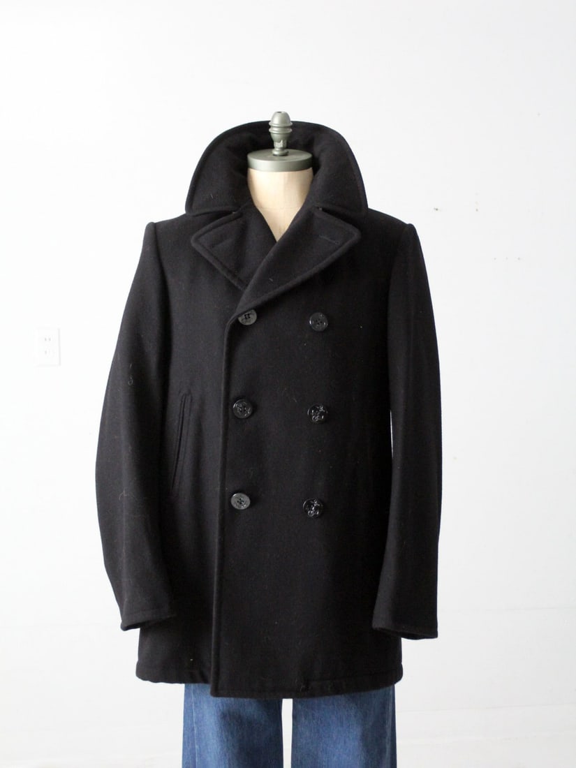 Classic Vintage US Navy Peacoat Black Wool with Anchor Buttons: Classic Vintage US Navy Peacoat Black Wool with Anchor Buttons This vintage US Navy peacoat showcases a timeless design with a classic fit, crafted from black wool and adorned with traditional black a