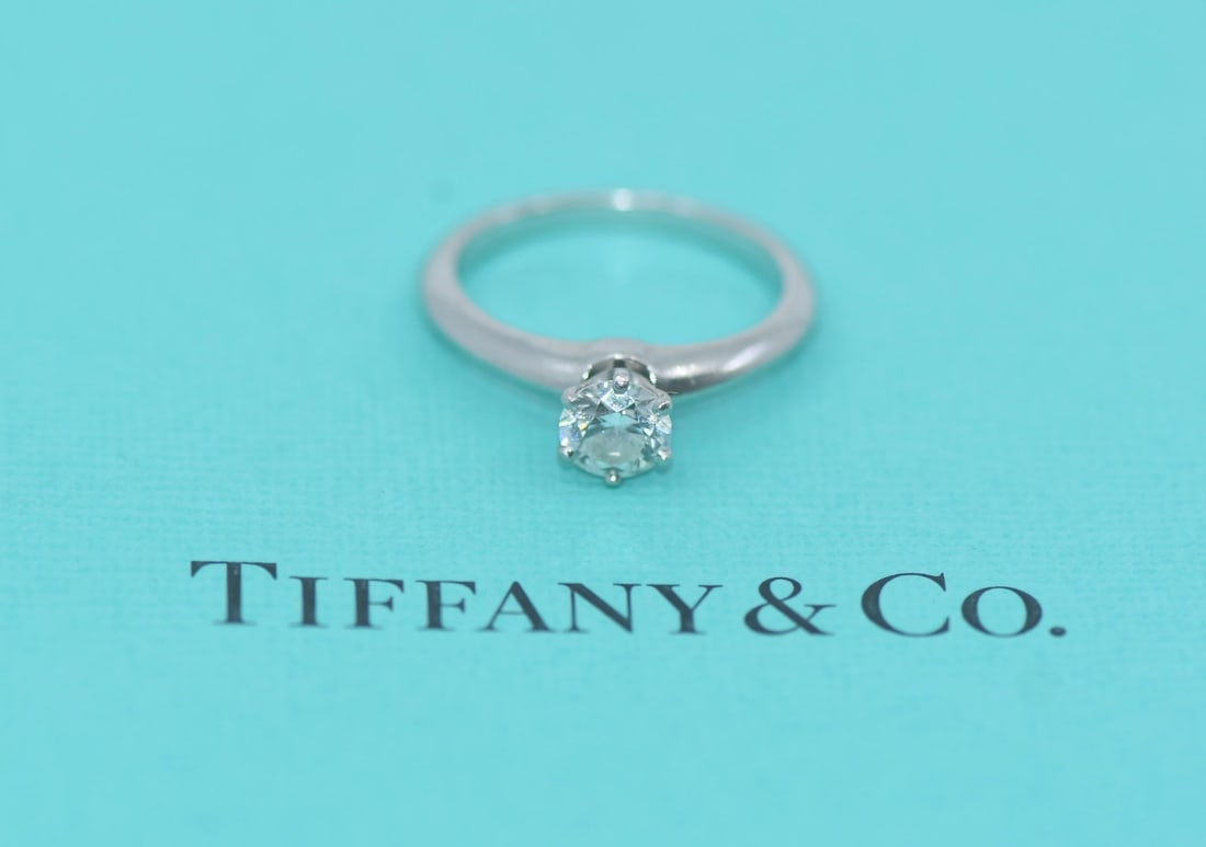 Tiffany & Co Platinum Diamond Engagement Ring 0.59ct G/SI1 Size 5.5 Authentic: Tiffany & Co Platinum Diamond Engagement Ring 0.59ct G/SI1 Size 5.5 Authentic This exquisite engagement ring from Tiffany & Co. features a stunning round diamond with a weight of 0.59 carats, graded G