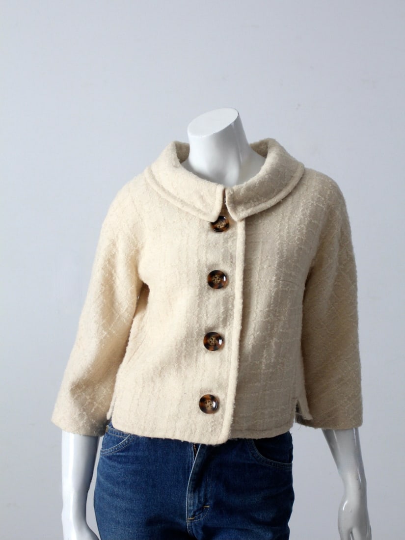 1960s Vintage Brentwood Cream Boucle Jacket with 3/4 Sleeves: 1960s Vintage Brentwood Cream Boucle Jacket with 3/4 Sleeves Step back in time with this charming 1960s vintage Brentwood boucle jacket. Crafted in a soft cream boucle fabric, this jacket features sty