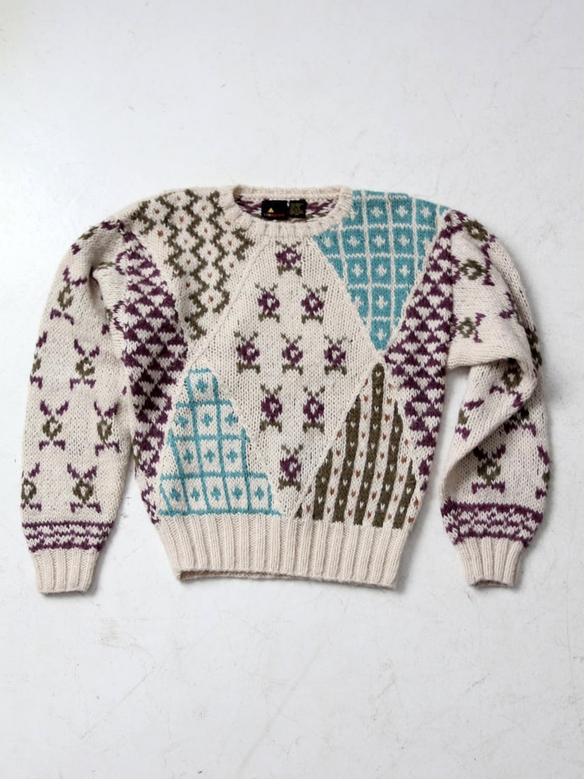 Vintage Liz Sport Geometric Floral Sweater Pullover: Vintage Liz Sport Geometric Floral Sweater Pullover This vintage Liz Sport sweater showcases a unique blend of geometric and floral patterns, featuring a stylish cream, purple, and blue color palette.
