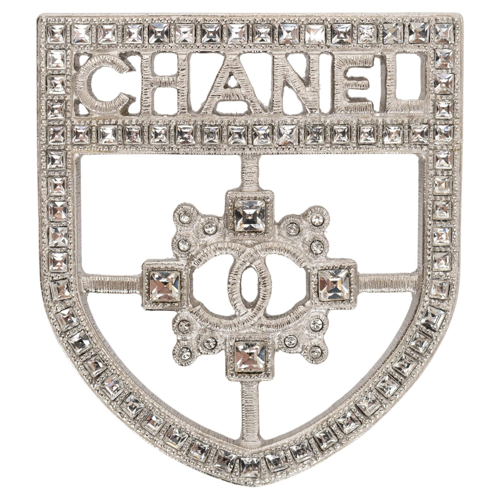 Chanel 2016 Crystal Crest Shield Brooch with Velvet Pouch: Chanel 2016 Crystal Crest Shield Brooch with Velvet Pouch This exquisite Chanel Crystal Crest Shield Brooch is a stunning accessory from the 2016 collection, designed to add a touch of elegance to any