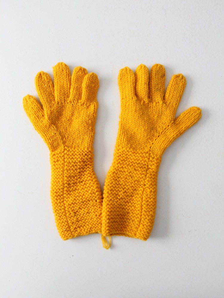 1960s Vintage Hand Knit Yellow Gold Gloves with Wrist Warmers: 1960s Vintage Hand Knit Yellow Gold Gloves with Wrist Warmers Explore a unique pair of vintage hand-knit gloves from the 1960s, beautifully crafted in a vibrant yellow gold hue. These gloves feature l