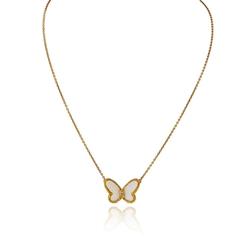 Van Cleef & Arpels 18K Yellow Gold Butterfly Pendant with White Coral: Van Cleef & Arpels 18K Yellow Gold Butterfly Pendant with White Coral This exquisite necklace from Van Cleef & Arpels showcases a beautifully crafted butterfly pendant made from 18K yellow gold and wh