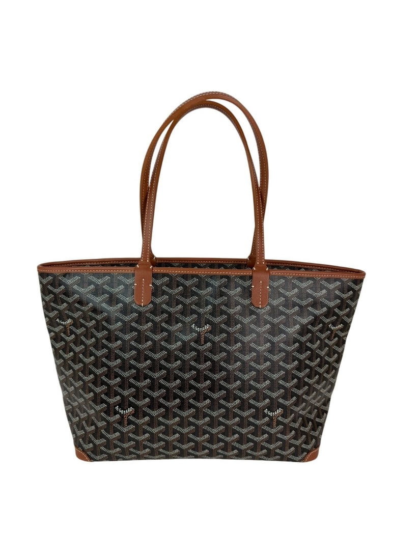 Goyard Goyardine Artois MM Black Tote Bag with Silver Hardware: Goyard Goyardine Artois MM Black Tote Bag with Silver Hardware Introducing the Goyard Goyardine Artois MM Tote Bag, a stunning blend of functionality and style. This medium-sized tote features a sleek