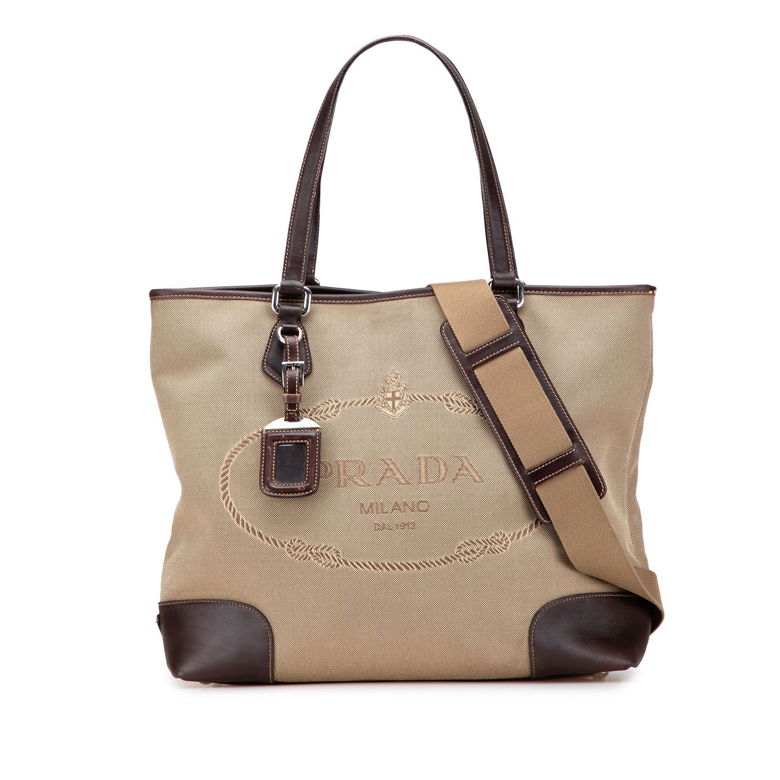 Prada Canapa Logo Satchel Leather Trimmed Brown Fabric Bag: Prada Canapa Logo Satchel Leather Trimmed Brown Fabric Bag This stylish Prada satchel combines a durable canvas body with elegant leather trim, making it a chic addition to your collection. The bag fe