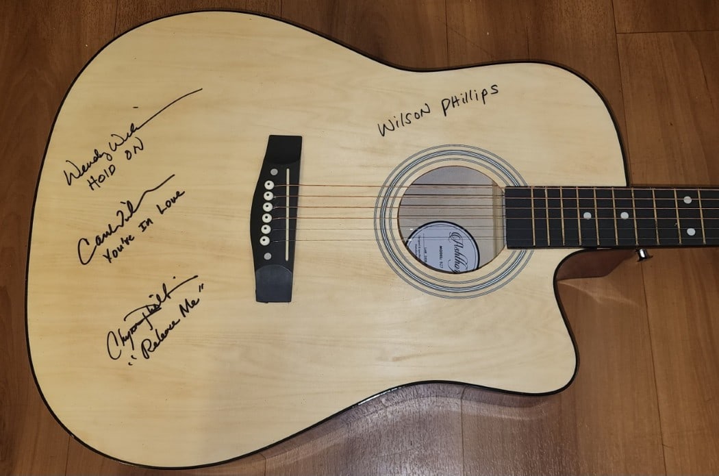 Wilson Phillips Signed Guitar with Lyrics by Chynna Carnie Wendy JSA Authenticated: Wilson Phillips Signed Guitar with Lyrics by Chynna Carnie Wendy JSA Authenticated This is a Wilson Phillips signed band guitar featuring the authentic signatures of Chynna Phillips, Carnie Wilson, an