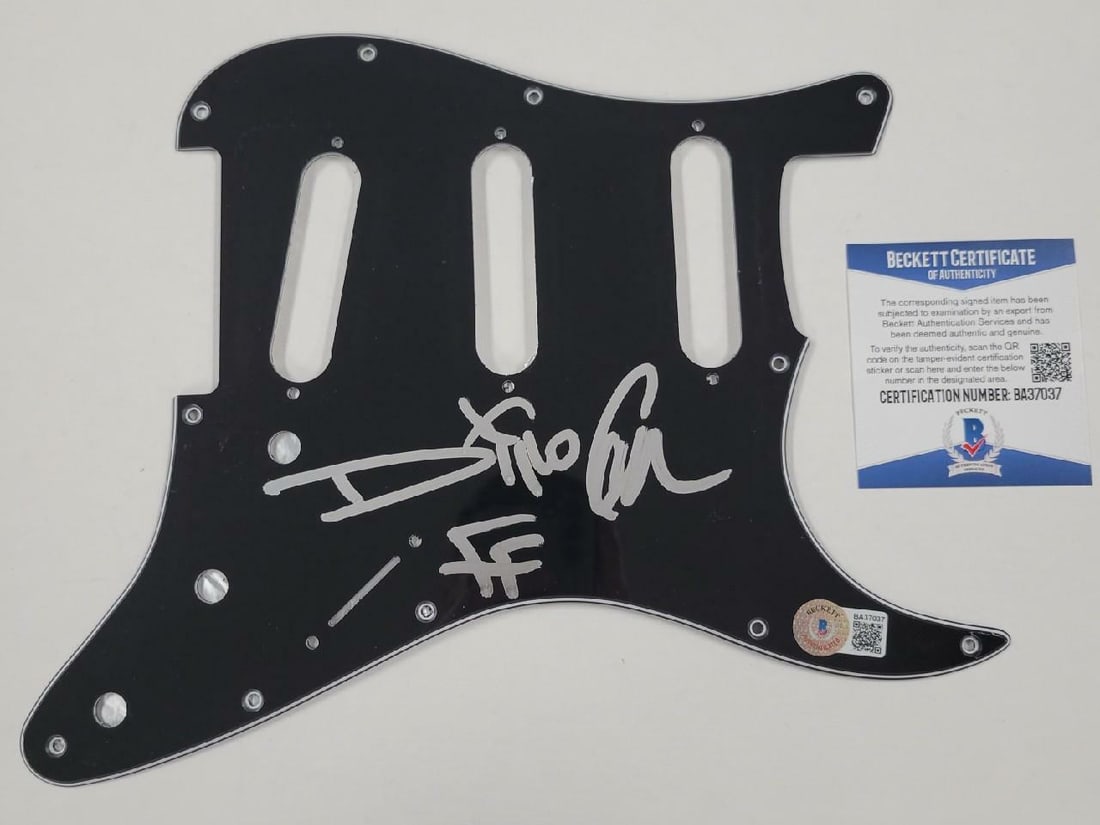 Dino Cazares Signed Electric Guitar Pickguard Fear Factory BAS COA: Dino Cazares Signed Electric Guitar Pickguard Fear Factory BAS COA This authentic black electric guitar pickguard is signed by Dino Cazares, the renowned guitarist of Fear Factory. The pickguard is a