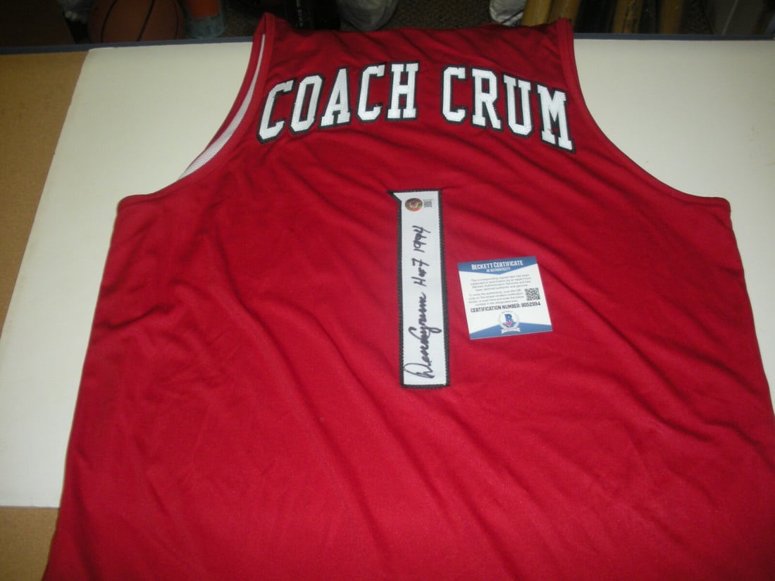 Denny Crum Signed Adidas Louisville Practice Basketball Jersey: Denny Crum Signed Adidas Louisville Practice Basketball Jersey This official Adidas practice-used jersey is signed by Denny Crum, a notable figure in basketball history. The jersey is an original piec