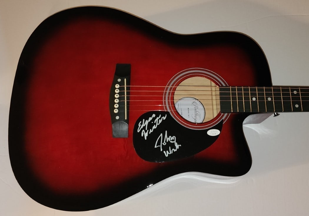 Edgar Winter Johnny Winter Signed Acoustic Guitar JSA Authenticated: Edgar Winter Johnny Winter Signed Acoustic Guitar JSA Authenticated This is a pre-owned acoustic guitar autographed by renowned musicians Edgar Winter and Johnny Winter, featuring their signatures on