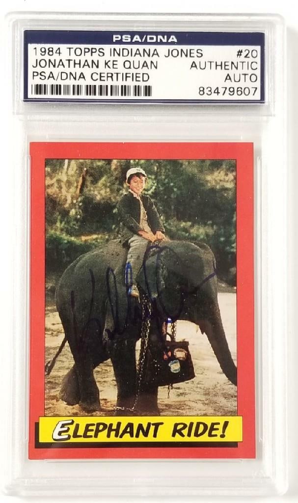 Jonathan Ke Quan Signed 1984 Topps Indiana Jones Card PSA/DNA: Jonathan Ke Quan Signed 1984 Topps Indiana Jones Card PSA/DNA Own a piece of cinematic history with this signed 1984 Topps Indiana Jones #20 'Elephant Ride' trading card. Featuring an authentic autogr