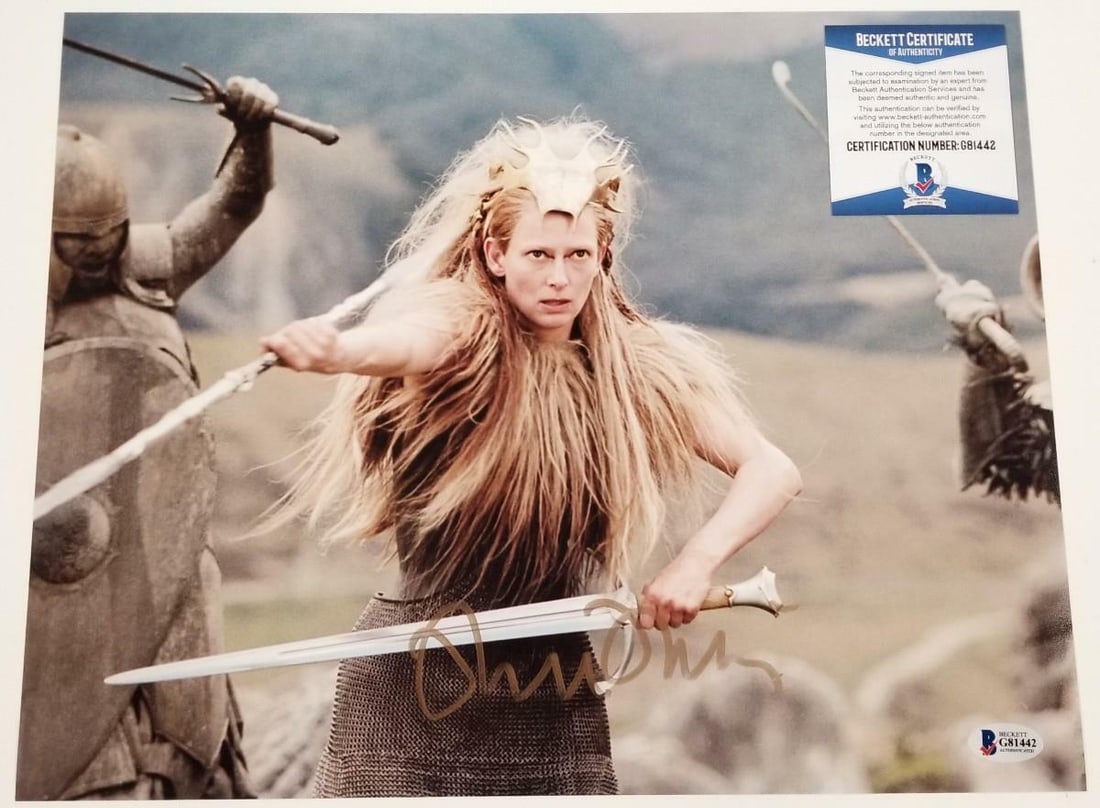 Tilda Swinton Autographed Narnia 11x14 Photo White Witch Beckett COA: Tilda Swinton Autographed Narnia 11x14 Photo White Witch Beckett COA This stunning 11x14 photograph features Tilda Swinton as the White Witch from the iconic Narnia series, beautifully autographed by