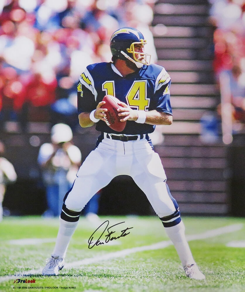 Dan Fouts Signed Chargers Navy Jersey 16x20 Action Photo with COA: Dan Fouts Signed Chargers Navy Jersey 16x20 Action Photo with COA This remarkable item features a 16x20 photo capturing Dan Fouts in action, signed by the legendary quarterback himself. The photo show