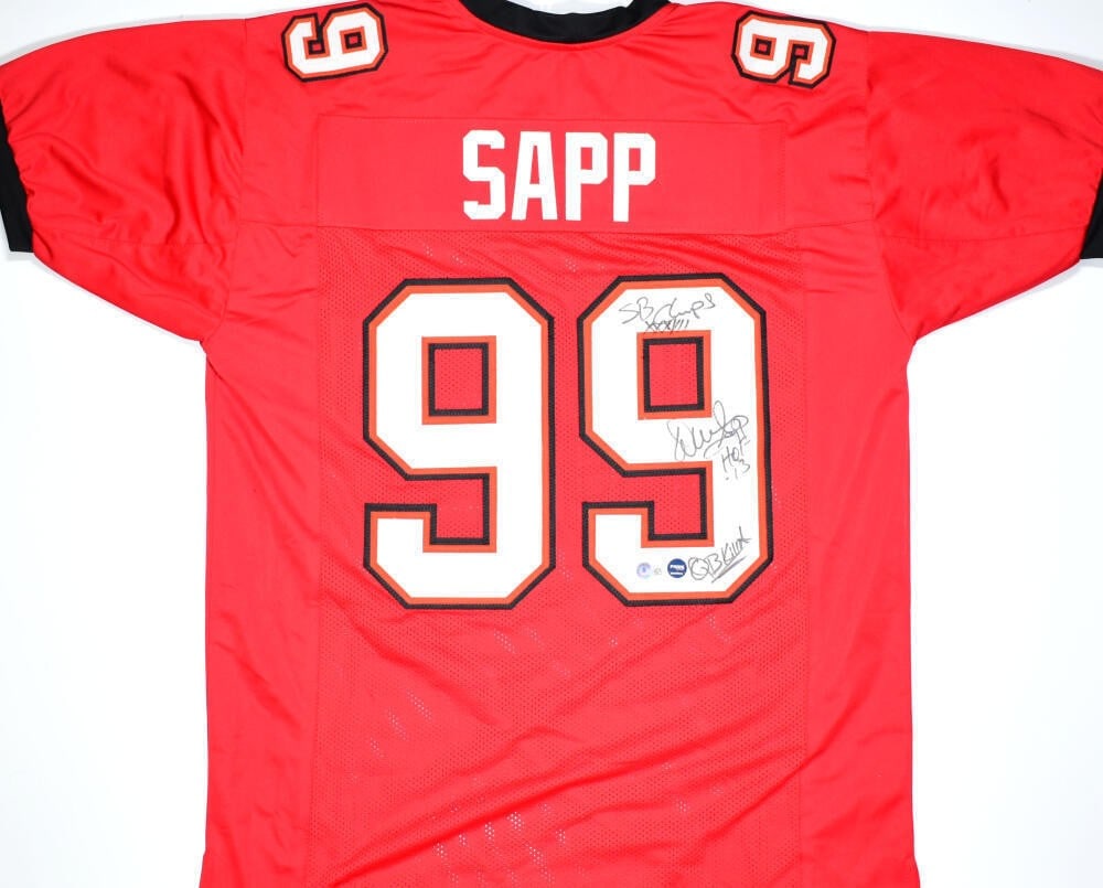 Warren Sapp Signed Red Buccaneers Jersey with 3 Inscriptions Beckett Authenticated: Warren Sapp Signed Red Buccaneers Jersey with 3 Inscriptions Beckett Authenticated This is an original red pro style jersey autographed by Warren Sapp, featuring three inscriptions. The jersey represe