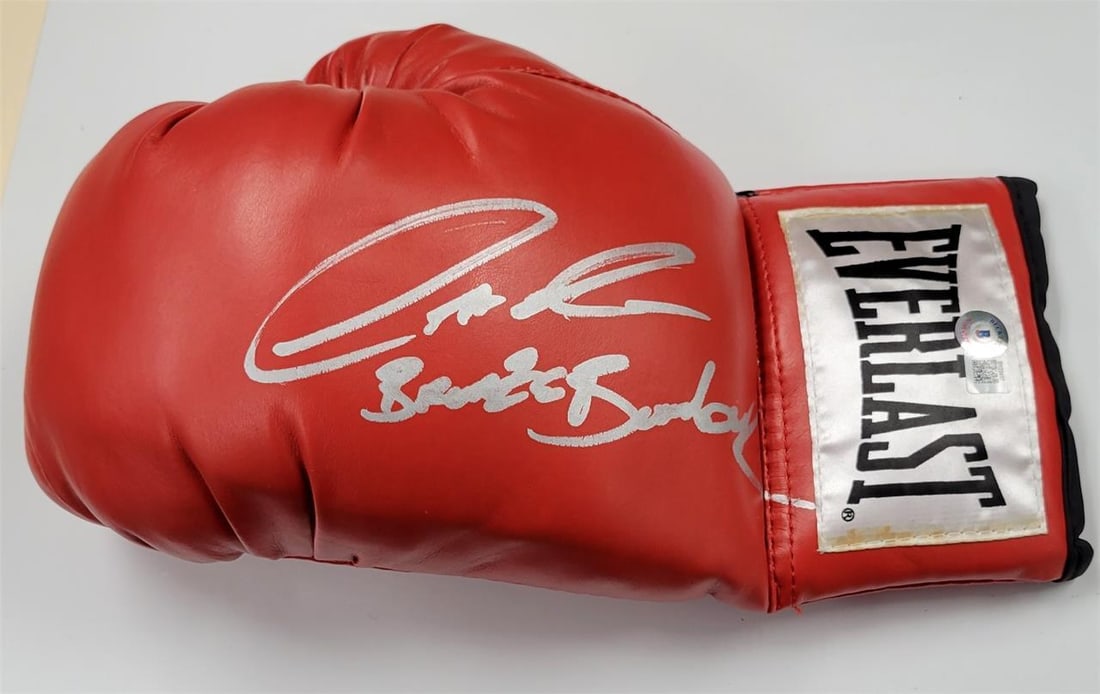 Deontay Wilder Autographed Boxing Glove Bronze Bomber Beckett BAS: Deontay Wilder Autographed Boxing Glove Bronze Bomber Beckett BAS This is an original boxing glove signed by Deontay Wilder, known as the "Bronze Bomber." The glove features authentication from Becket