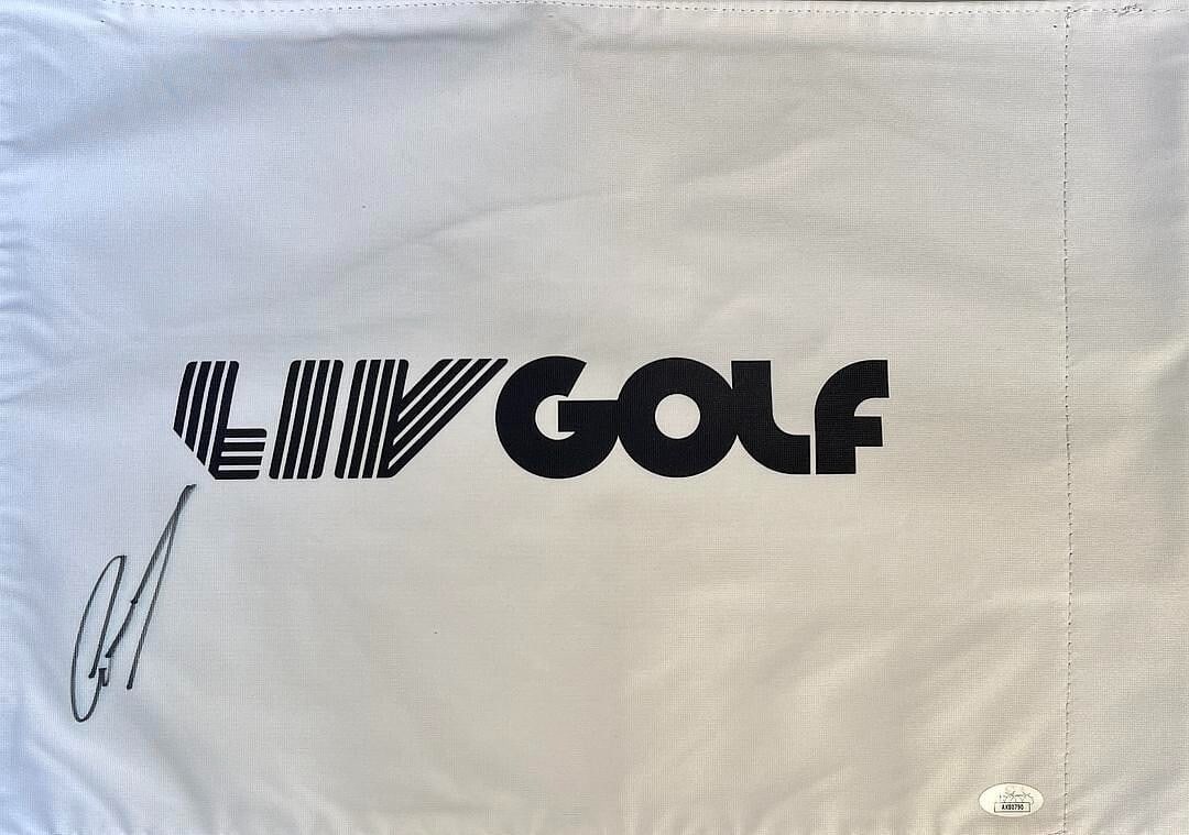 Greg Norman Signed LIV Golf #18 Pin Flag JSA AK80790: Greg Norman Signed LIV Golf #18 Pin Flag JSA AK80790 Own a piece of golfing history with this official LIV Golf #18 pin flag, signed by the legendary golfer Greg Norman, also known as 'The Shark.' Thi