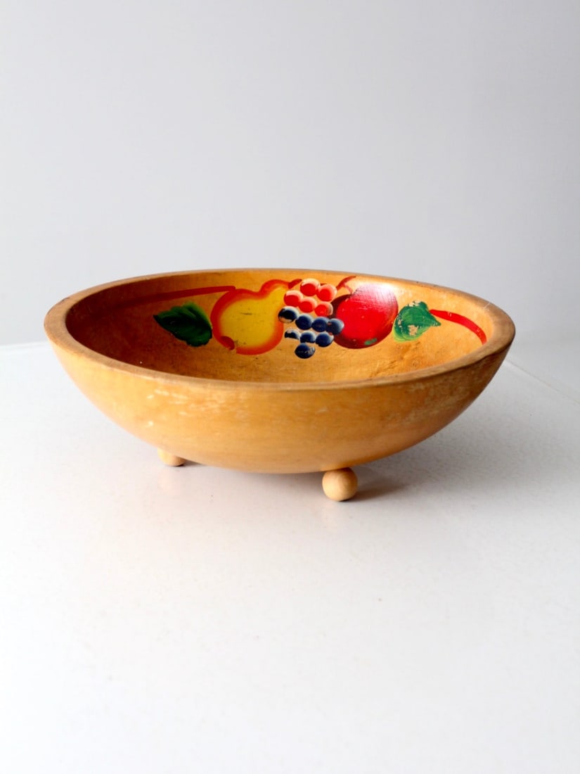 Hand Painted 1950s Wooden Bowl with Fruit Motif and Red Rim Accent: Hand Painted 1950s Wooden Bowl with Fruit Motif and Red Rim Accent This vintage 1950s wooden footed bowl showcases hand-painted fruit motifs and a slender red band around the inside rim. It features a