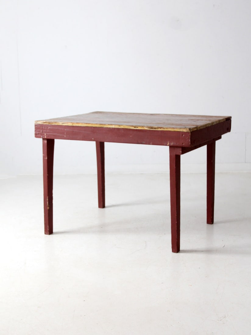 Rustic Vintage Farmhouse Table Oxblood Red Tapered Legs: Rustic Vintage Farmhouse Table Oxblood Red Tapered Legs This rustic vintage primitive farmhouse table showcases a beautifully crafted slat wood top that features a rich patina and timeworn character.