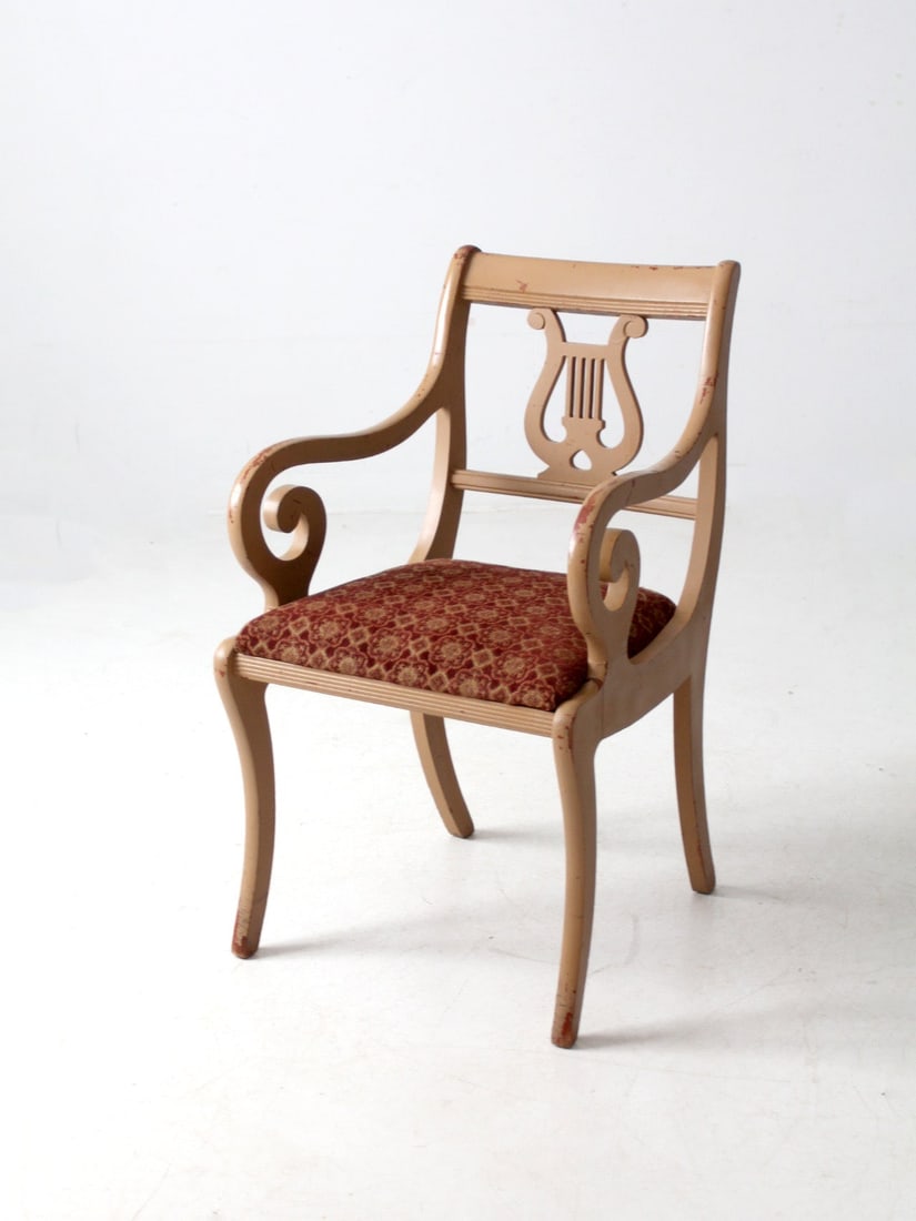 Antique Lyre Back Armchair with Scroll Arms and Aged Finish: Antique Lyre Back Armchair with Scroll Arms and Aged Finish This exquisite antique lyre back armchair showcases elegantly designed scroll arms and splayed legs, complemented by a beautifully carved ly