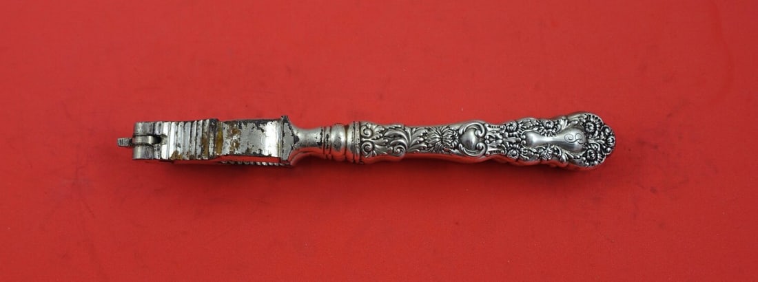 Gorham Imperial Chrysanthemum Sterling Silver Nut Cracker 6 5/8": Gorham Imperial Chrysanthemum Sterling Silver Nut Cracker 6 5/8" Discover the elegance of the Imperial Chrysanthemum nut cracker by Gorham. This exquisite piece features a sterling silver hollow handl