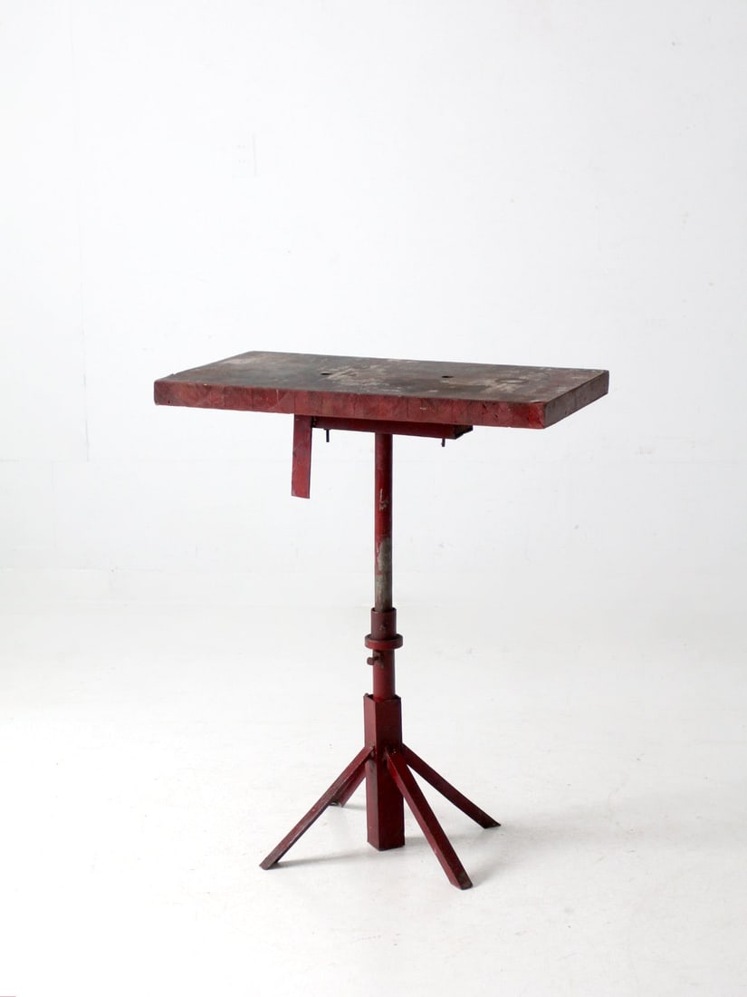 Vintage Industrial Table with Red Metal Base and Wooden Top: Vintage Industrial Table with Red Metal Base and Wooden Top This vintage industrial table showcases a striking red metal base paired with a sturdy wooden top, embodying a classic industrial design. It