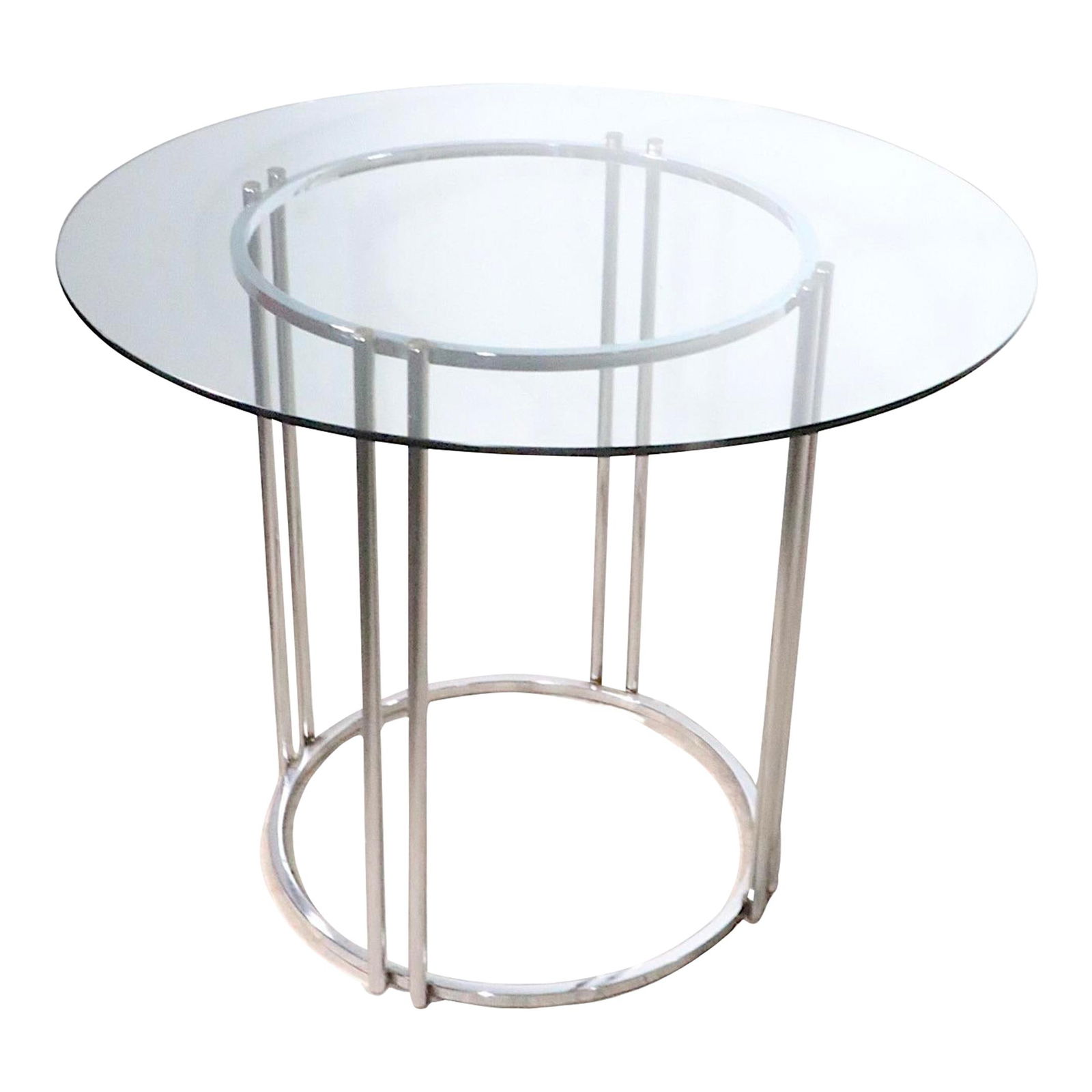 1970s Round Chrome and Glass Dining Table Baughman Style: 1970s Round Chrome and Glass Dining Table Baughman Style This elegant round dining table features a thick glass top and a sleek chrome base, offering a stylish blend of function and design. Reminiscen