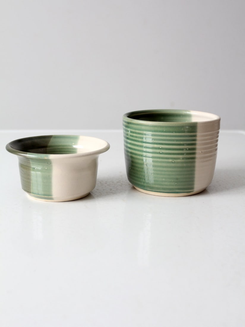 Handmade Vintage Ceramic Nesting Bowl Set Signed Green White Glaze: Handmade Vintage Ceramic Nesting Bowl Set Signed Green White Glaze This vintage handmade ceramic nesting bowl set showcases a beautiful two-tone glaze in calming shades of green and white. The design