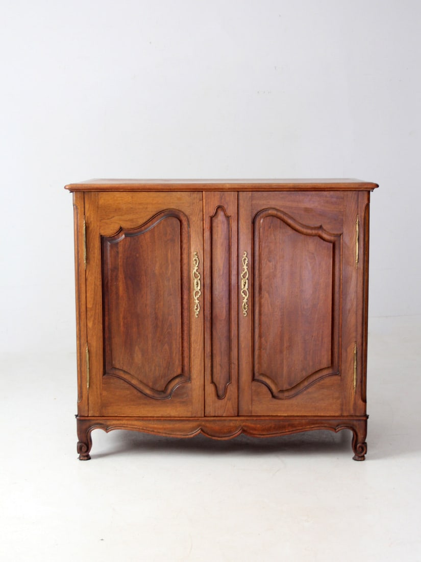 Vintage French Louis XV Style Cabinet with Drawer Storage: Vintage French Louis XV Style Cabinet with Drawer Storage This Vintage French Louis XV-style cabinet is a stunning piece that showcases elegant paneled doors and graceful cabriole legs, complemented b