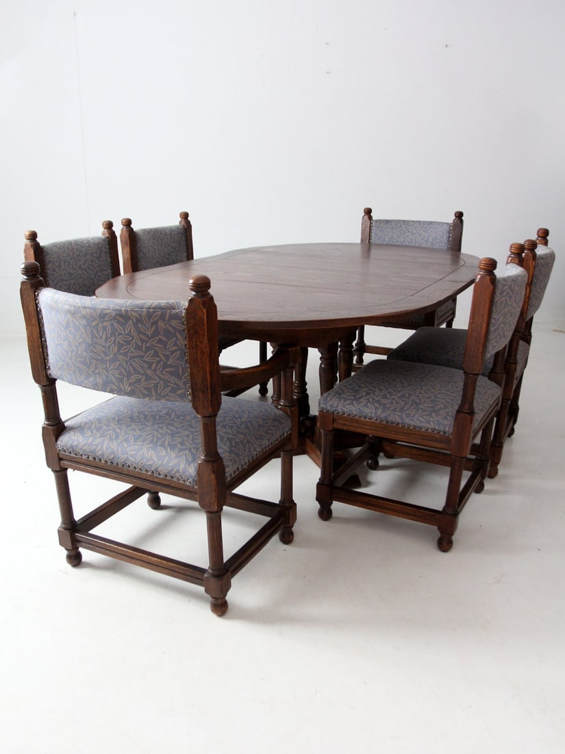 Vintage Jacobean Revival Dining Set of 6 with Blue Upholstery: Vintage Jacobean Revival Dining Set of 6 with Blue Upholstery Elevate your dining experience with this Vintage Jacobean Revival Style Set of 6. Perfect for intimate dinners or gatherings, the round ta