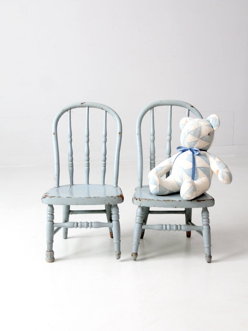 Charming Pair of Vintage Spindle Back Kids Chairs: Charming Pair of Vintage Spindle Back Kids Chairs This charming pair of vintage kids' spindle back chairs features a delightful light blue paint that has gracefully worn away, revealing the natural