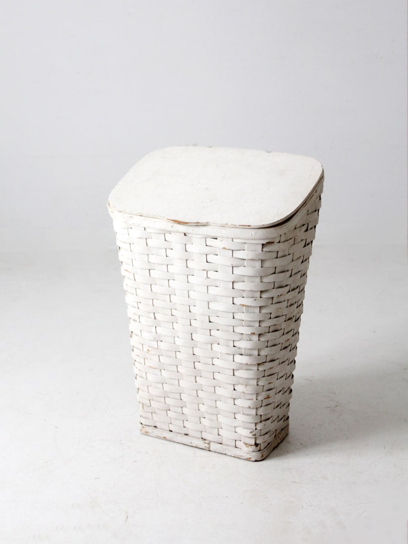 Charming Antique Woven Hamper with Slanted Lid and Green Interior: Charming Antique Woven Hamper with Slanted Lid and Green Interior This antique splint weave hamper showcases a charming woven white basket design, complemented by a slanted wooden lid that opens via a