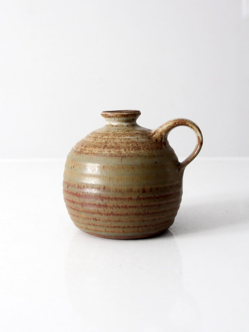 Handmade Vintage Studio Pottery Jug Vase Olive Brown Glaze: Handmade Vintage Studio Pottery Jug Vase Olive Brown Glaze This vintage studio pottery jug vase showcases a beautiful handmade design by the artist. Featuring a warm olive brown glaze, it has a distin