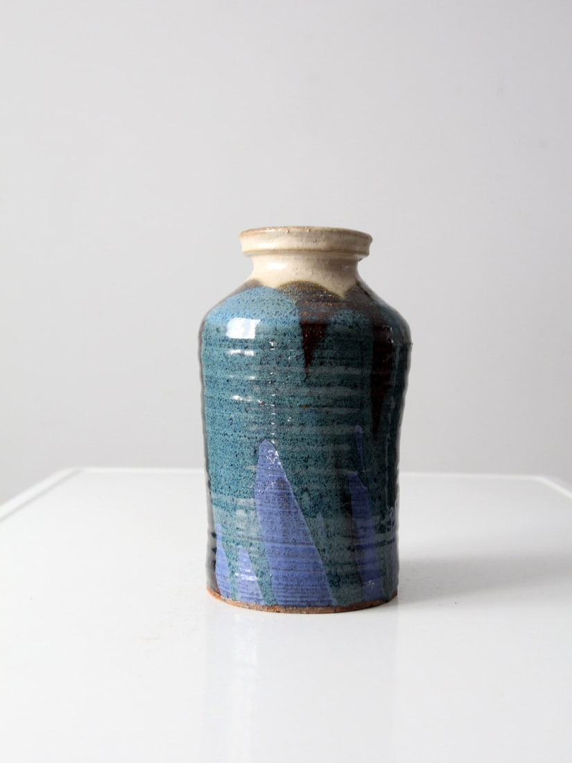 Handcrafted Vintage Studio Pottery Vase Blue Green Glaze 9.5": Handcrafted Vintage Studio Pottery Vase Blue Green Glaze 9.5" This vintage studio pottery vase showcases a beautifully hand-crafted design with a striking glaze of blue, green, black, and cream. It st