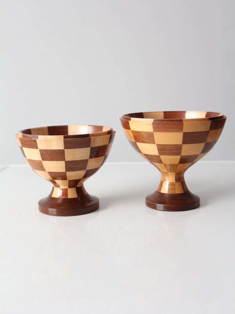 Vintage Handmade Checkerboard Wood Pedestal Bowls Pair: Vintage Handmade Checkerboard Wood Pedestal Bowls Pair This stunning pair of vintage handmade wood pedestal bowls showcases a unique checkerboard pattern, adding an eye-catching element to your servin